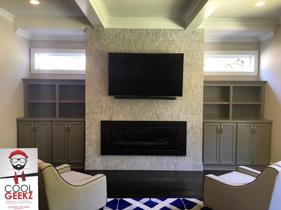mounted flat screen tv on wall above fireplace in Lawrenceville, GA